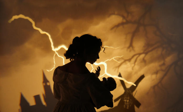 A sepia image of Sarah Fornace as Mary Shelley holding a monster