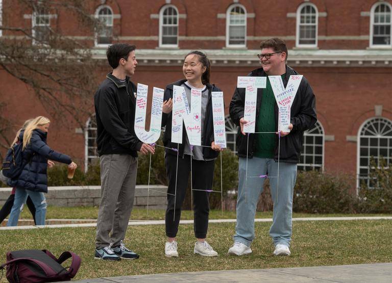 3 students holding a UNITY sign
