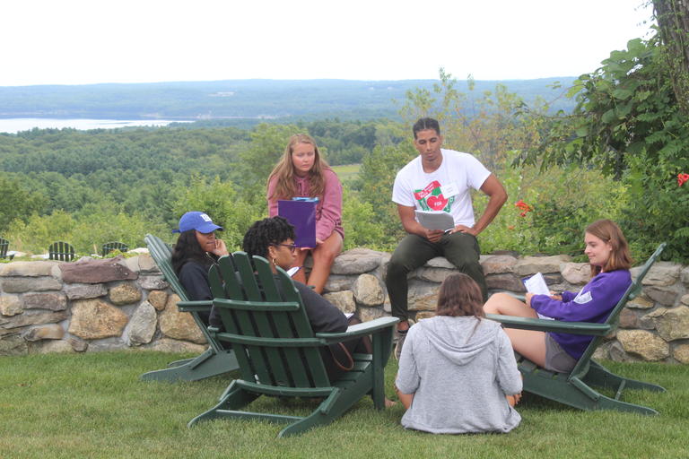 students sitting outside of the retreat building