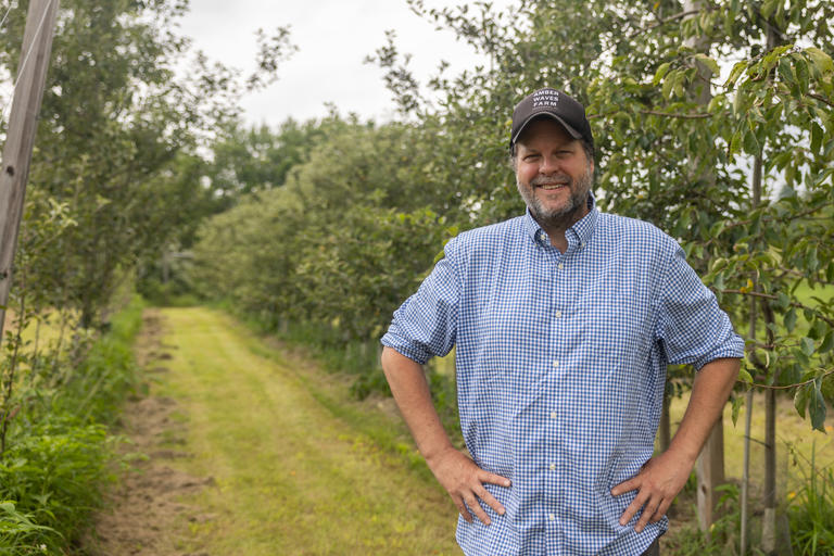 Prof. Daina Harvey in an apple orchard