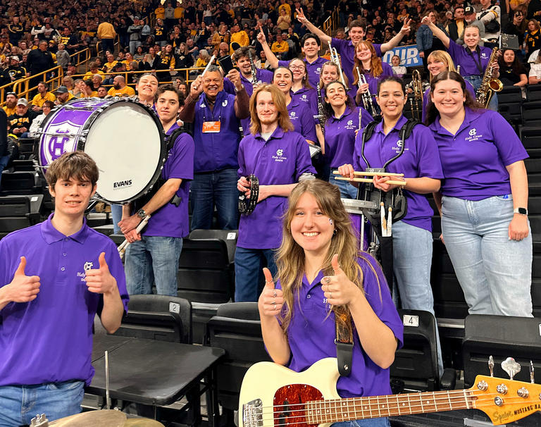 Holy Cross Pep Band and President Rougeau playing at a basketball game