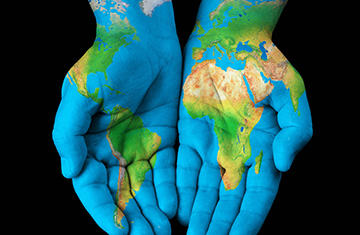 Hands with blue outline of Earth