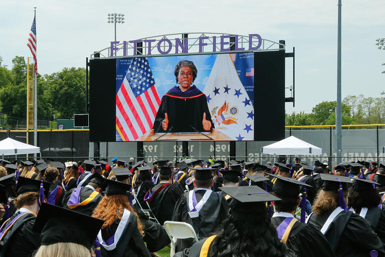 Ambassador Linda Thomas-Greenfield delivers remarks via a large video board on Fitton Field before members of the Class of 2021 during Commencement Exercises