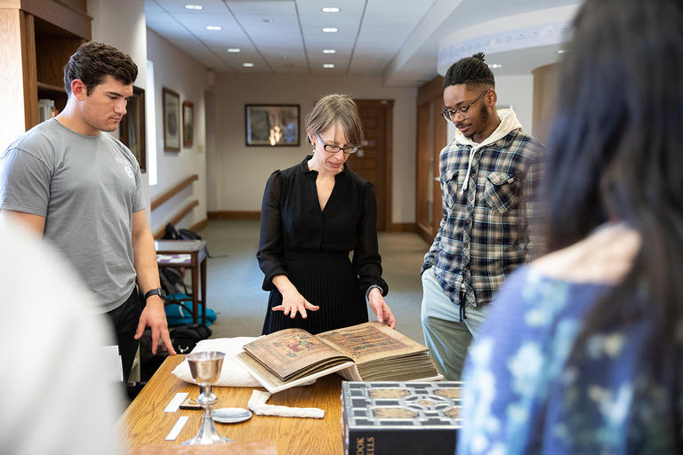 Senior lecturer Amanda Luyster conducts a course in the Archives and Special Collections area of Dinand Library at Holy Cross. 