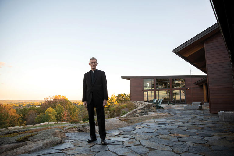 Fr. Boroughs, president of Holy Cross, standing in front of the Joyce Contemplative Center in West Boylston, Massachusetts. 