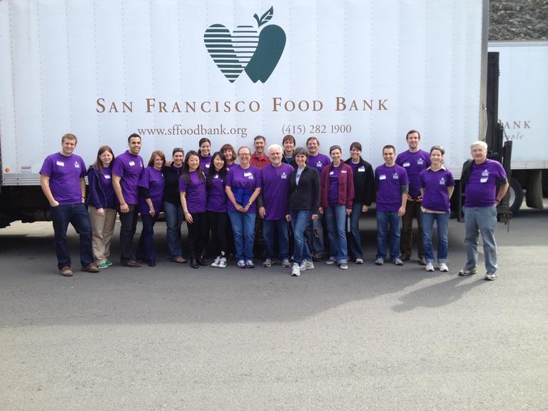 Group of people in purple t-shirts in front of San Francisco Food Bank truck