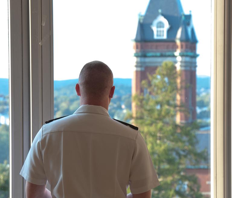 Back of person in uniform looking out of window
