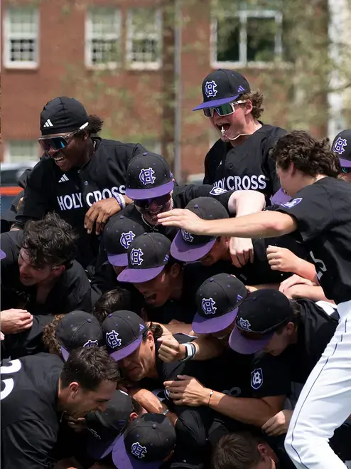The Holy Cross baseball team celebrates a championship win in 2026.