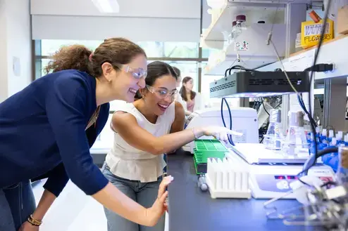 Two science research students examine extremophiles in a summer lab at Holy Cross