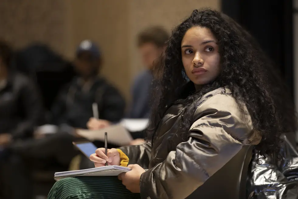 A student thinks through her next lines during a poetry workshop on campus.