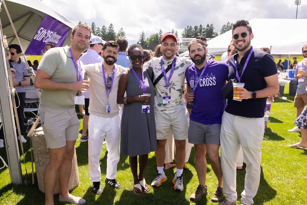 a group of alumni outside at a reunion picnic