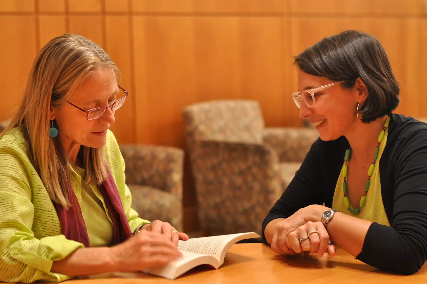 Professors from the Creative Writing Department study a text