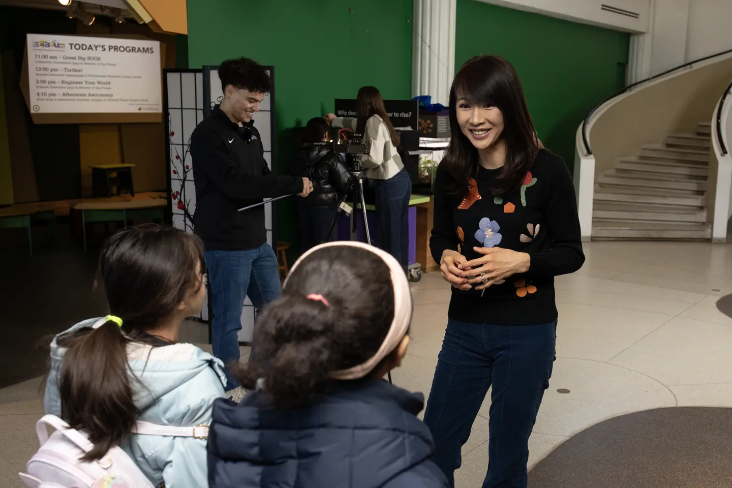 Holy Cross Psychology Professor Florence Angorra works with Holy Cross students Isabella Ruel ’25 and Angel Collazo ’26 as they conduct research with Worcester students at the Eco Terium in Worcester, Massachusetts