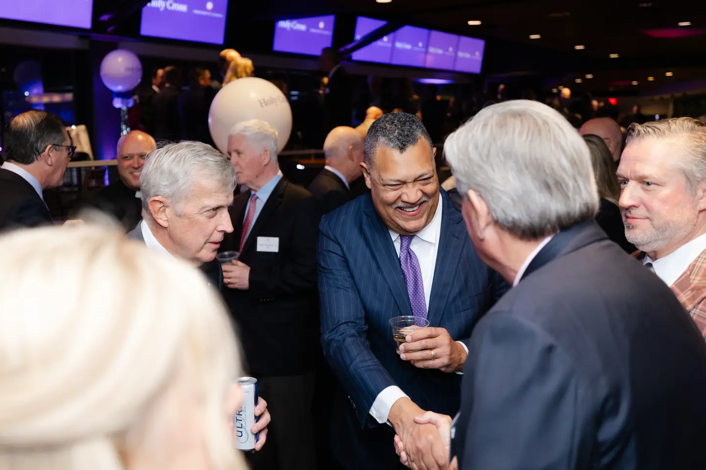 President Rougeau shakes hands at a President's Council event.
