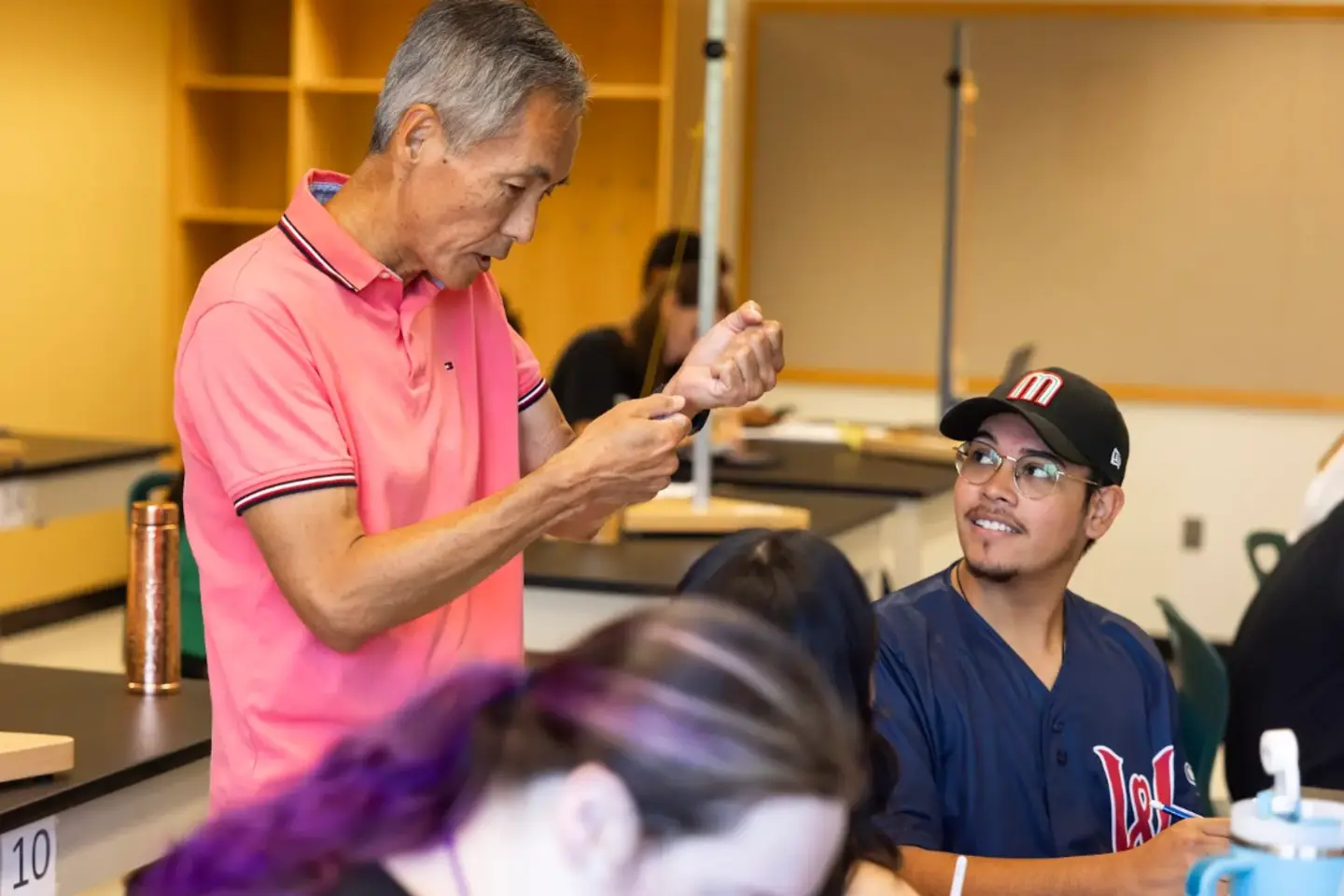 Professor Tom Narita in a classroom discussion with a Holy Cross student