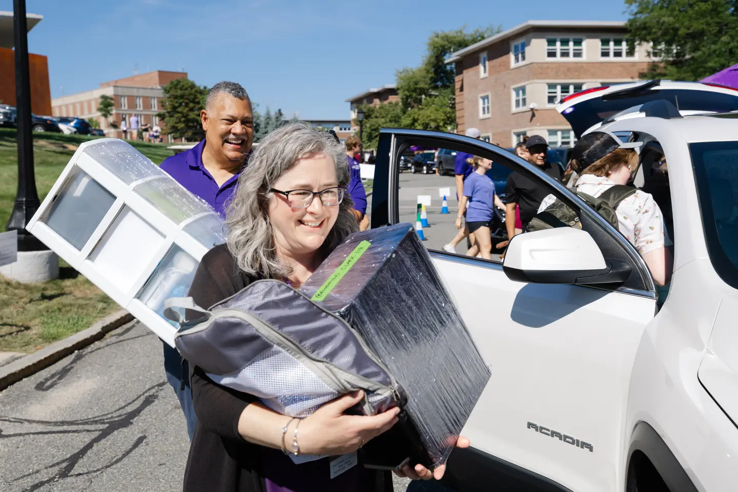 The Holy Cross president and Vice President for Student Development move students in during move-in day