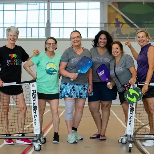 six women playing pickleball 