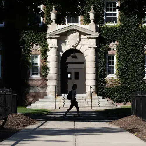 A student walks past Carlin Hall