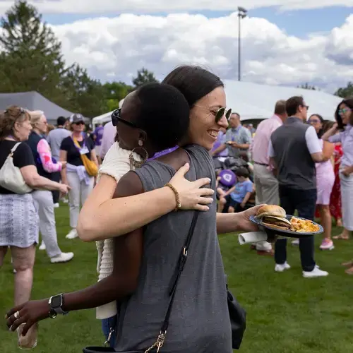 two folks hugging at a picnic