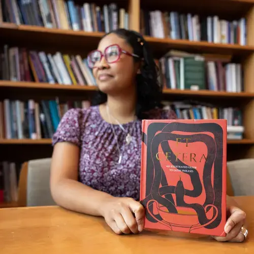 Fenwick Scholar Maia Lee-Chin '21 photographed in the Rehm Library at the College of the Holy Cross on September 23, 2024. Lee-Chin was on campus for a celebration of the publication of her first book Et Cetera: An Illustrated Guide to Latin Phrases. Her book was named an NPR "Book We Love" for Summer 2024 and is already a USA Today bestseller.