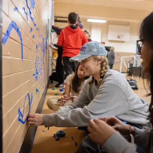 Holy Cross Students visit Rice Square School in Worcester to assist them in making Tape Art animals representing their cultural heritage on April 3rd, 2025