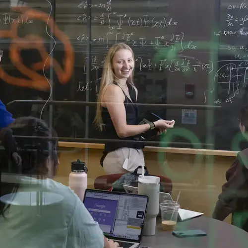 students in a classroom writing equations