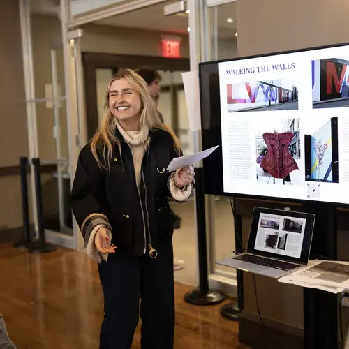 A student presents their work at the 2026 Holy Cross academic conference.