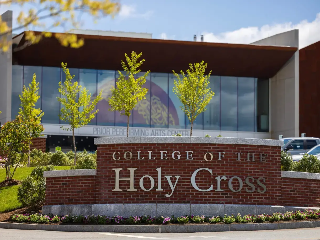 College of the Holy Cross sign in front of trees