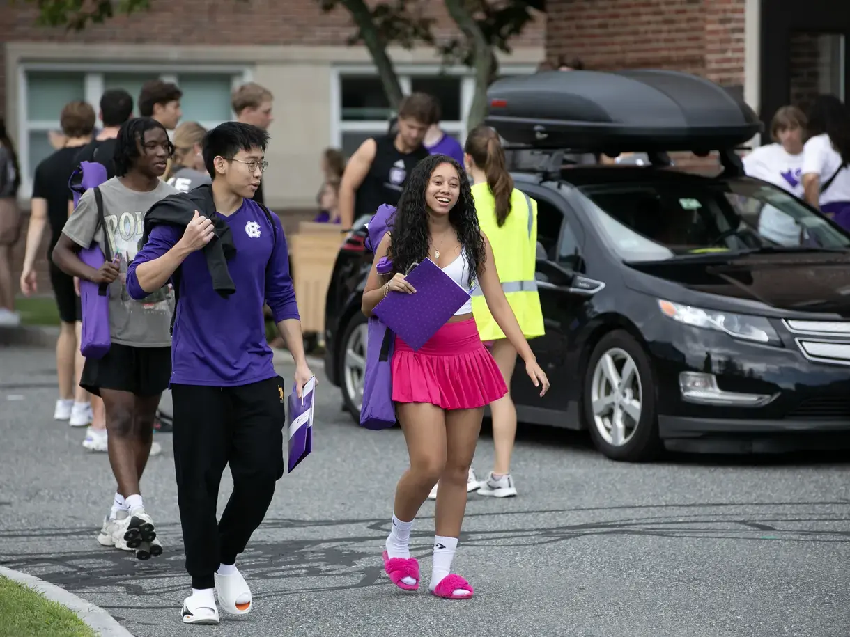 Students walking by a car during move-in day on campus