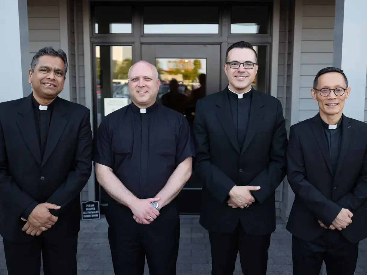 Four new members of the Jesuit residence with the rest of the S.J. campus community at The College of the Holy Cross in Worcester, MA.