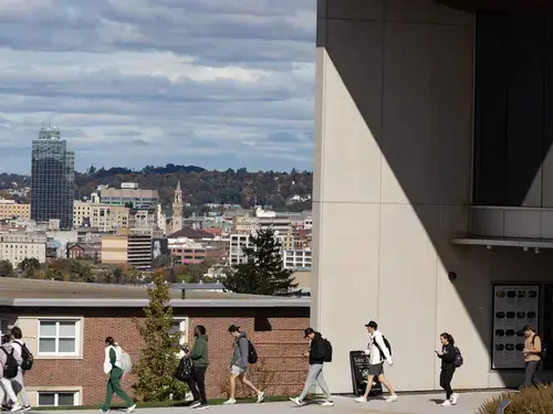 Students walking out of Prior Performing Arts Center with Worcester in the background