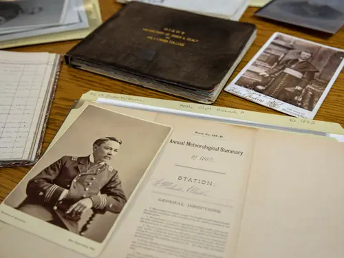 Archived photos of the Healy brothers and related books.