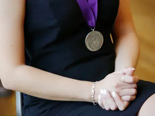 Medal awarded at Holy Cross commencement to student. 