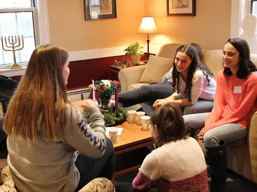 a group of students in the living room of campion house