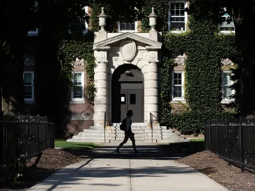 A student walks past Carlin Hall