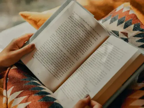Open book against aztetc print pillow 