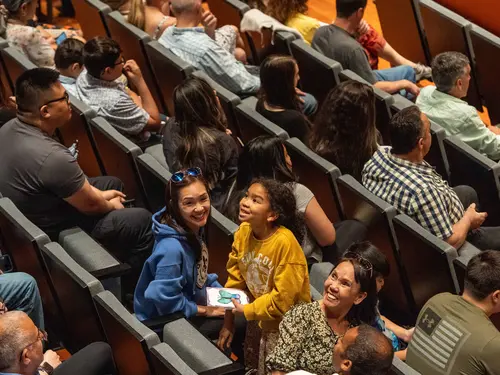An audience member smiles at a show at the Prior