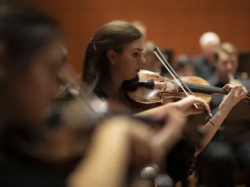 The Holy Cross Orchestra rehearses before celebrating the 50th Anniversary of Coeducation with a concert at the Luth Concert Hall on November 16, 2022 at the Prior Performing Arts Center in Worcester, Massachusetts.