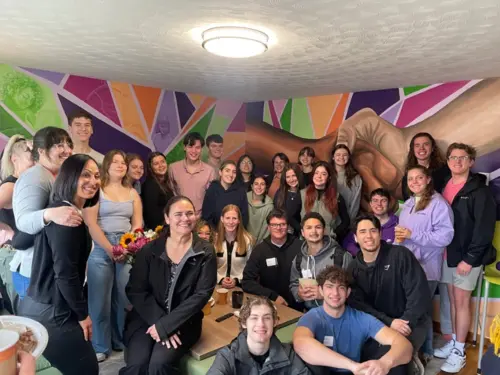 Students gather at the unveiling of a mural at Worcester House
