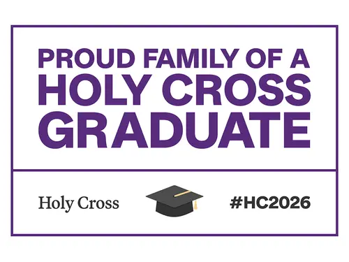 A yard sign reads "Proud Family of a Holy Cross Graduate"