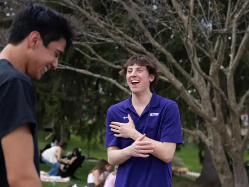 Students share a laugh on the campus of Holy Cross in Worcester.