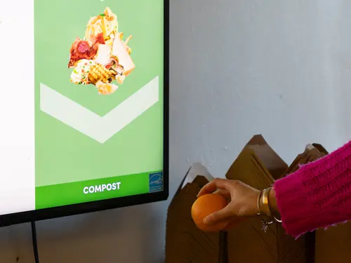 A student uses Oscar AI Waste Sort Technology at Holy Cross