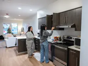 Students in townhouse kitchen