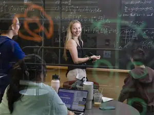 students in a classroom writing equations