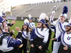The Holy Cross band gets hyped up during a practice on campus