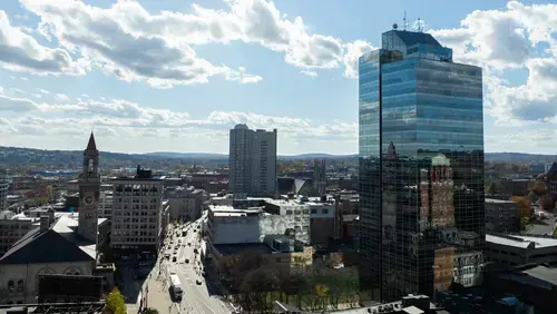 Aerial photo of downtown Worcester with the sun shining bright over the city.