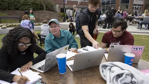 Professor Gareth Roberts with students outside on the Holy Cross campus