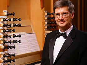 Portrait of Dr. Craig Cramer with organ in the background.