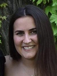 headshot of ali k stems tutor girl with long dark hair in formal dress outside with trees in background