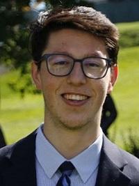 headshot of jack g stems tutor man with glasses tie and dress coat outside background